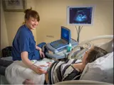 Doctor performs an ultrasound on expectant mother.